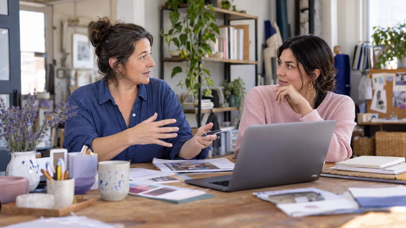 A small-business owner discussing hiring costs with a colleague.