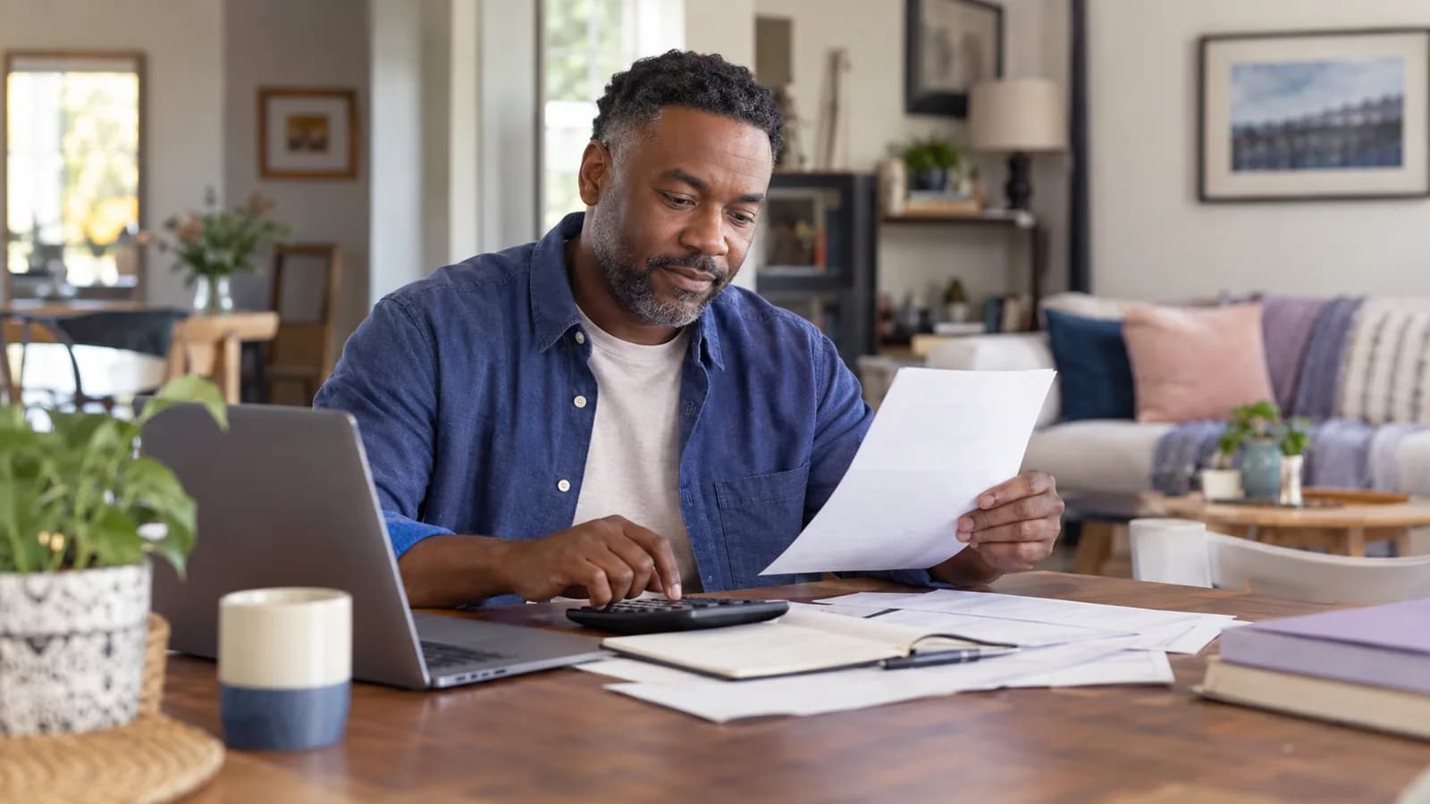 An employee reviewing a bonus payslip at home.